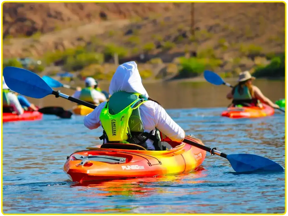 Guest paddling with arms raised in celebration on the Colorado River