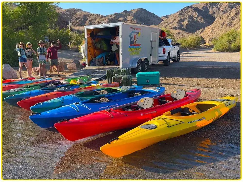 Fleet of kayaks staged on the shore for a full-day Black Canyon expedition