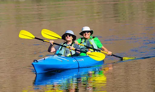 Couple paddling a tandem kayak